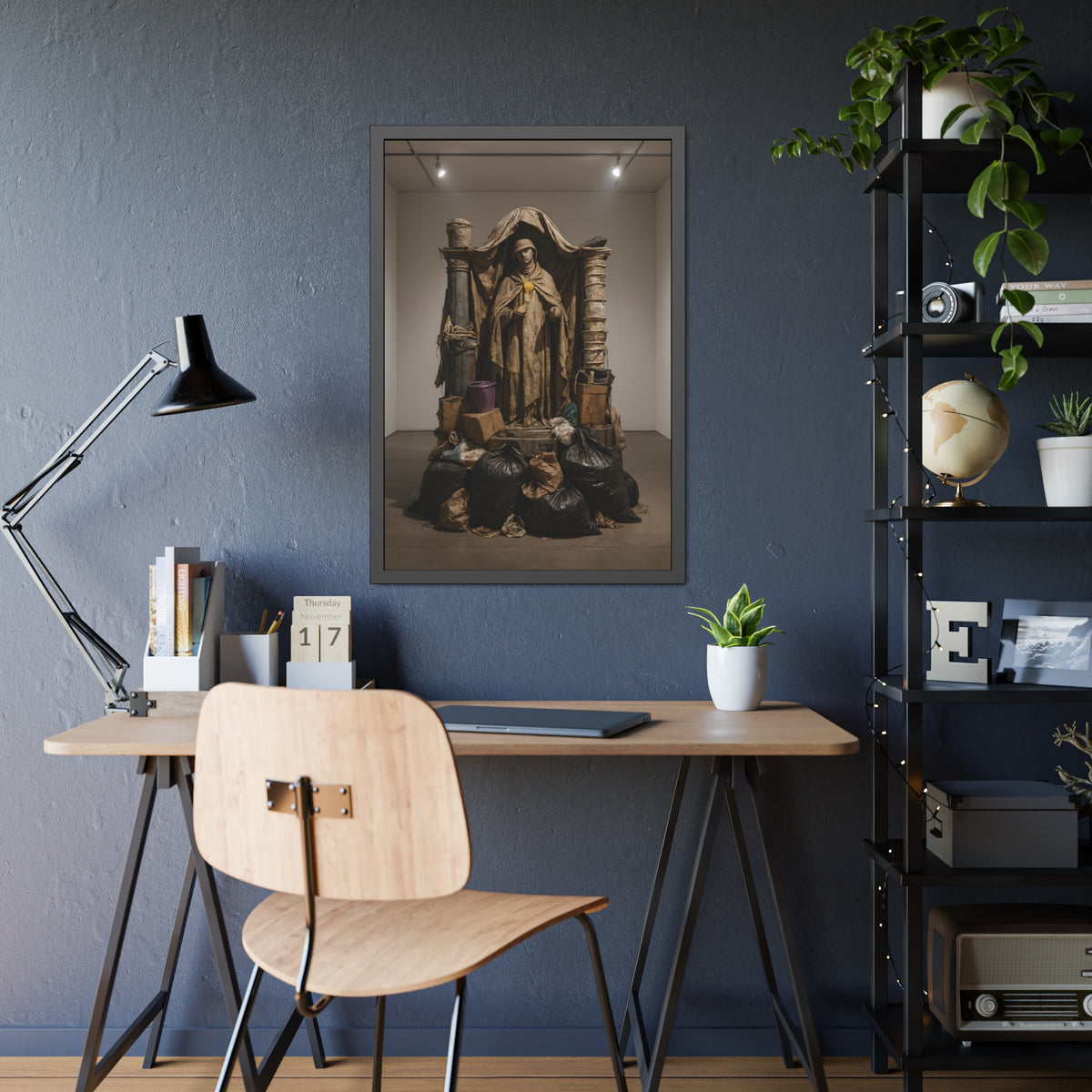 Draped standing figure under a canopy above a heap of black garbage bags. Saint Francis of the Black Bag by Garabaggio, framed fine art print hanging in a room.