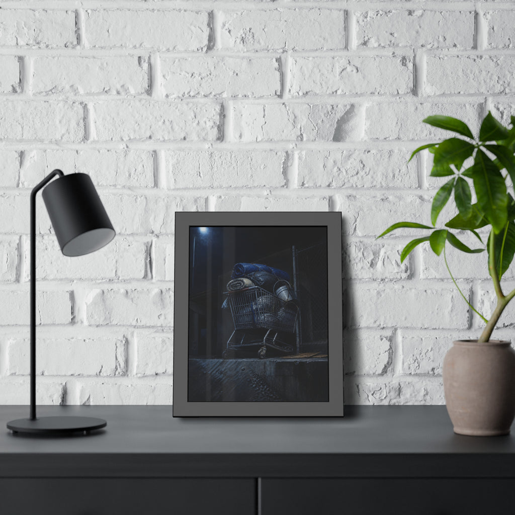A shopping cart piled with bedding and buckets under a streetlamp. The Loading of Another Life by Garabaggio, framed fine art print hanging in a room.