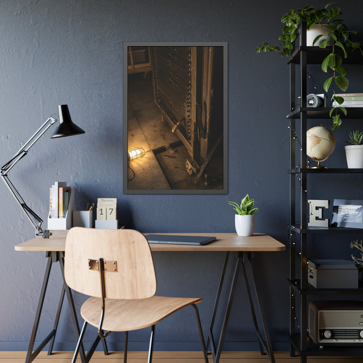A server rack on a concrete floor beside a caged work light. The Silence at Cutover by Garabaggio, framed fine art print hanging in a room.