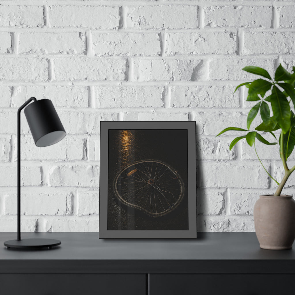 A buckled bicycle wheel on wet asphalt beneath a streetlight reflection. The Bend from Impact by Garabaggio, framed fine art print hanging in a room.