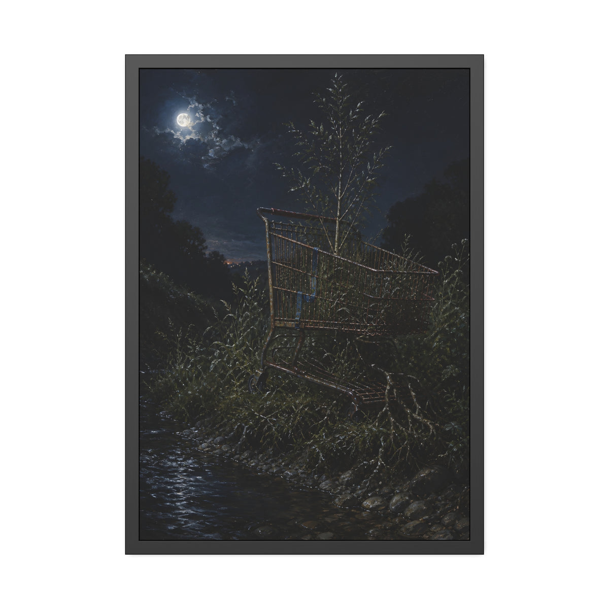 A shopping cart in creekside weeds with a sapling growing up through it. The Cart Grown Through by Garabaggio, framed fine art print, 28″ x 40″.