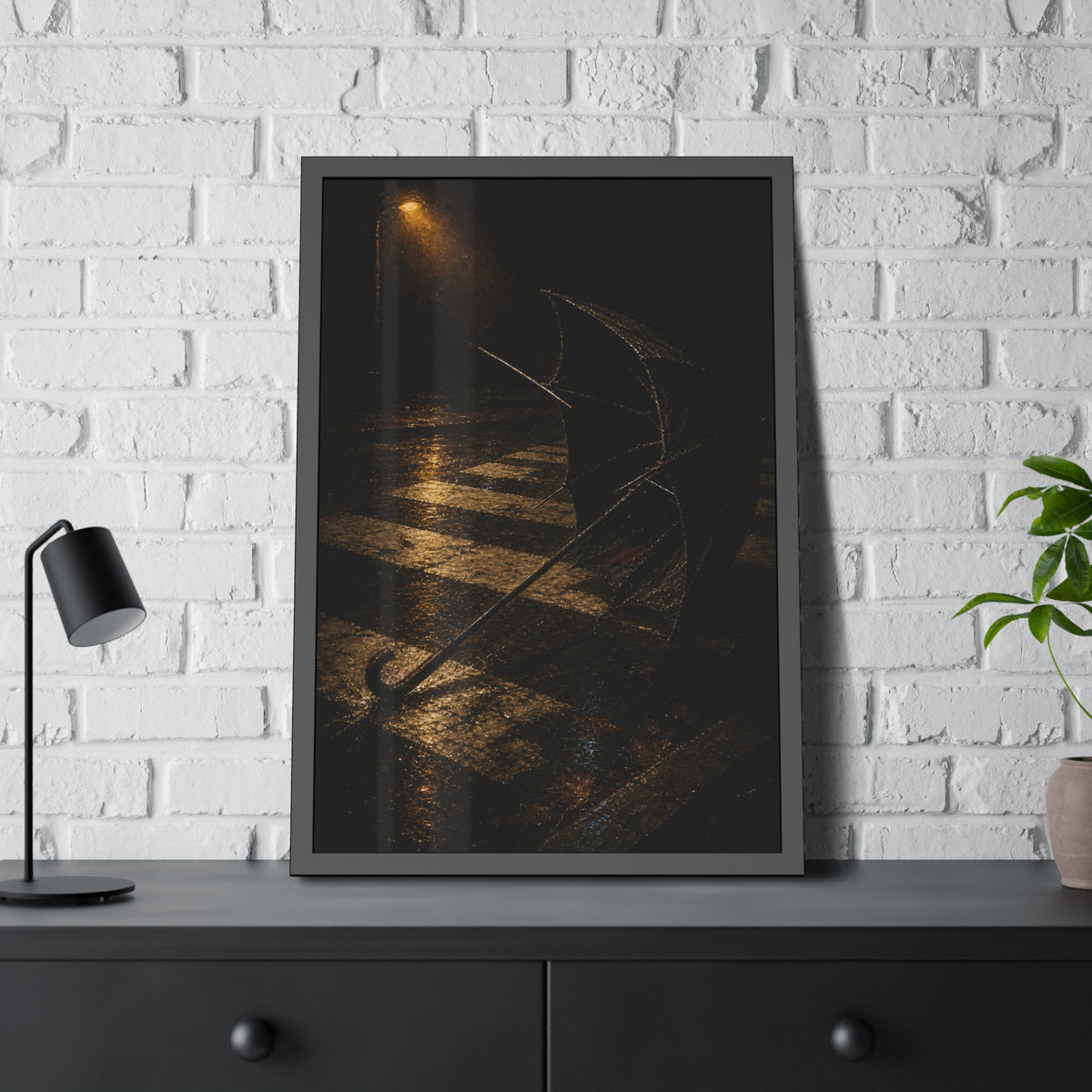 A blown out umbrella lying on wet checkered pavement under a street lamp. The Taking by the Wind by Garabaggio, framed fine art print hanging in a room.