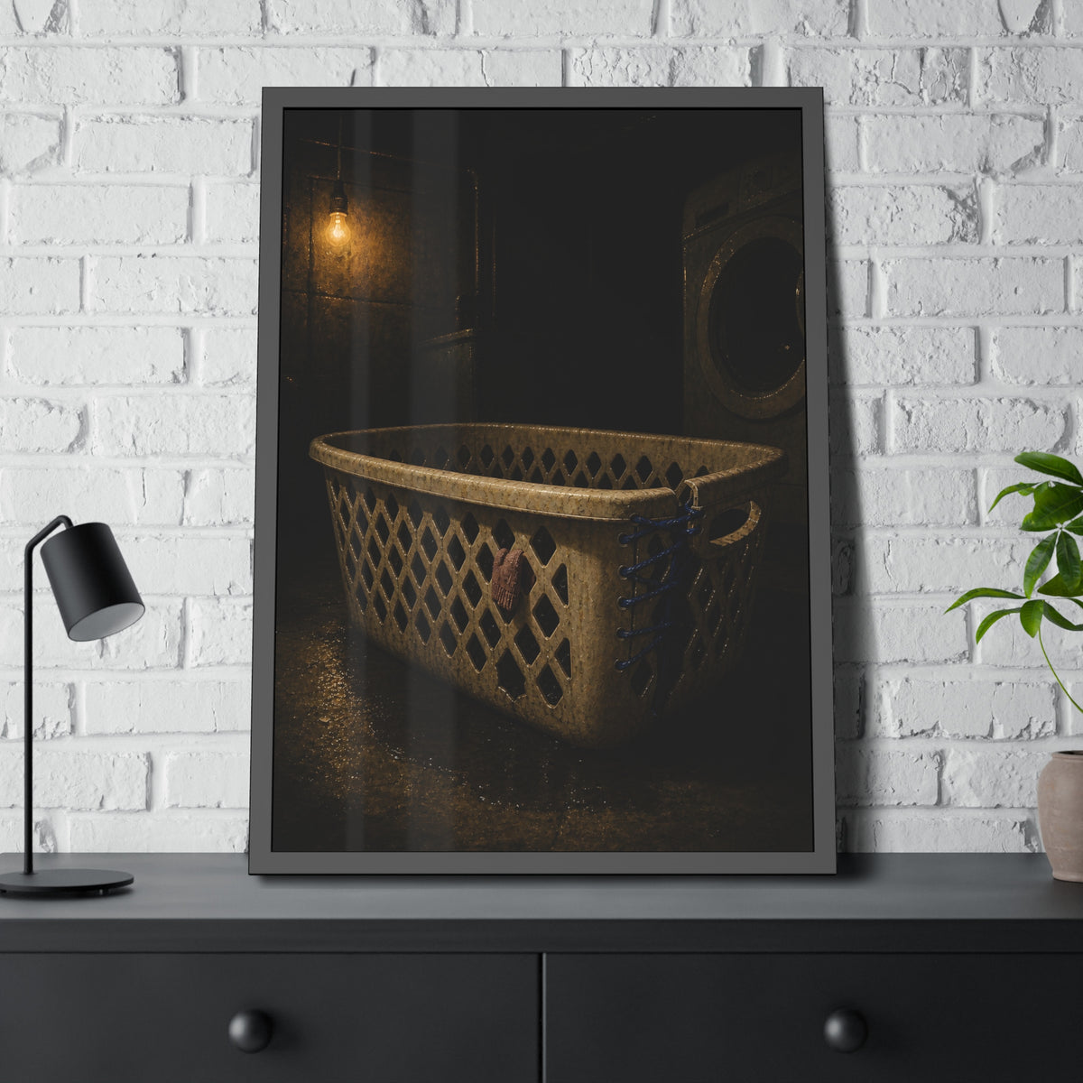A laundry basket laced shut with blue cord under a bare bulb. The Binding with Blue Cord by Garabaggio, framed fine art print hanging in a room.