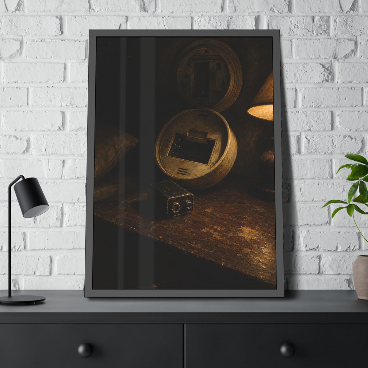 An open smoke detector on a wooden table beside a removed nine volt battery. The Silence After Removal by Garabaggio, framed fine art print hanging in a room.