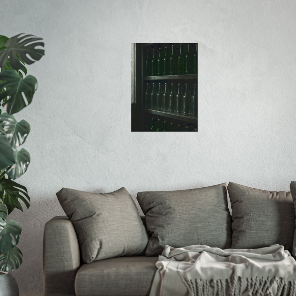Rows of empty bottles on dim metal shelves, green above and clear below. The Shelf of New Bottles by Garabaggio, fine art print hanging in a room.