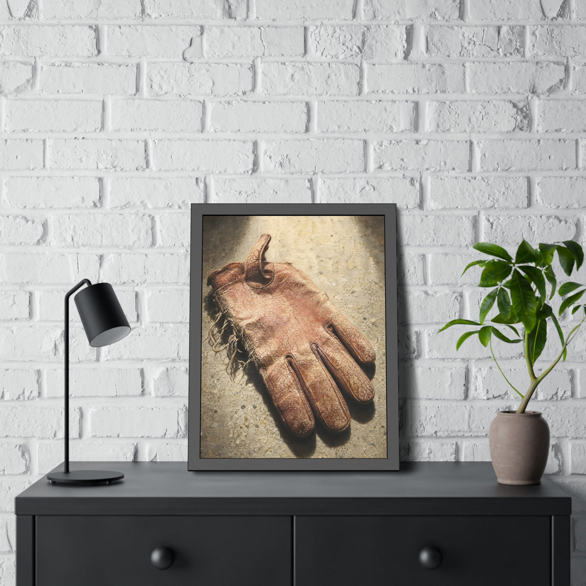 A cracked leather work glove lying on bright sunlit concrete. The Bleaching, Study of a Sun-Tired Glove by Garabaggio, framed fine art print hanging in a room.
