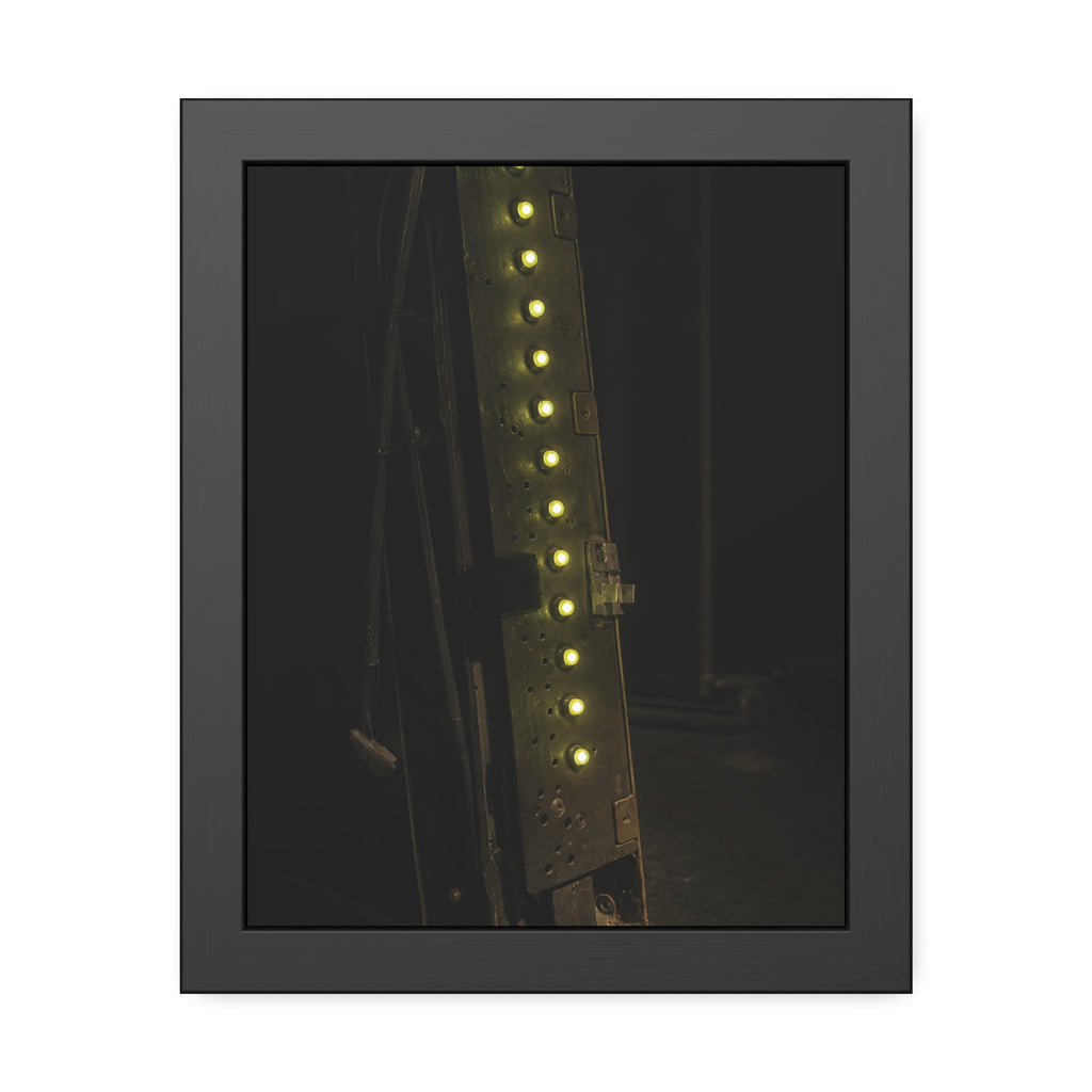 A dark rack panel with a vertical row of glowing green indicator lights. The First Green Choir by Garabaggio, framed fine art print, 11″ x 14″.