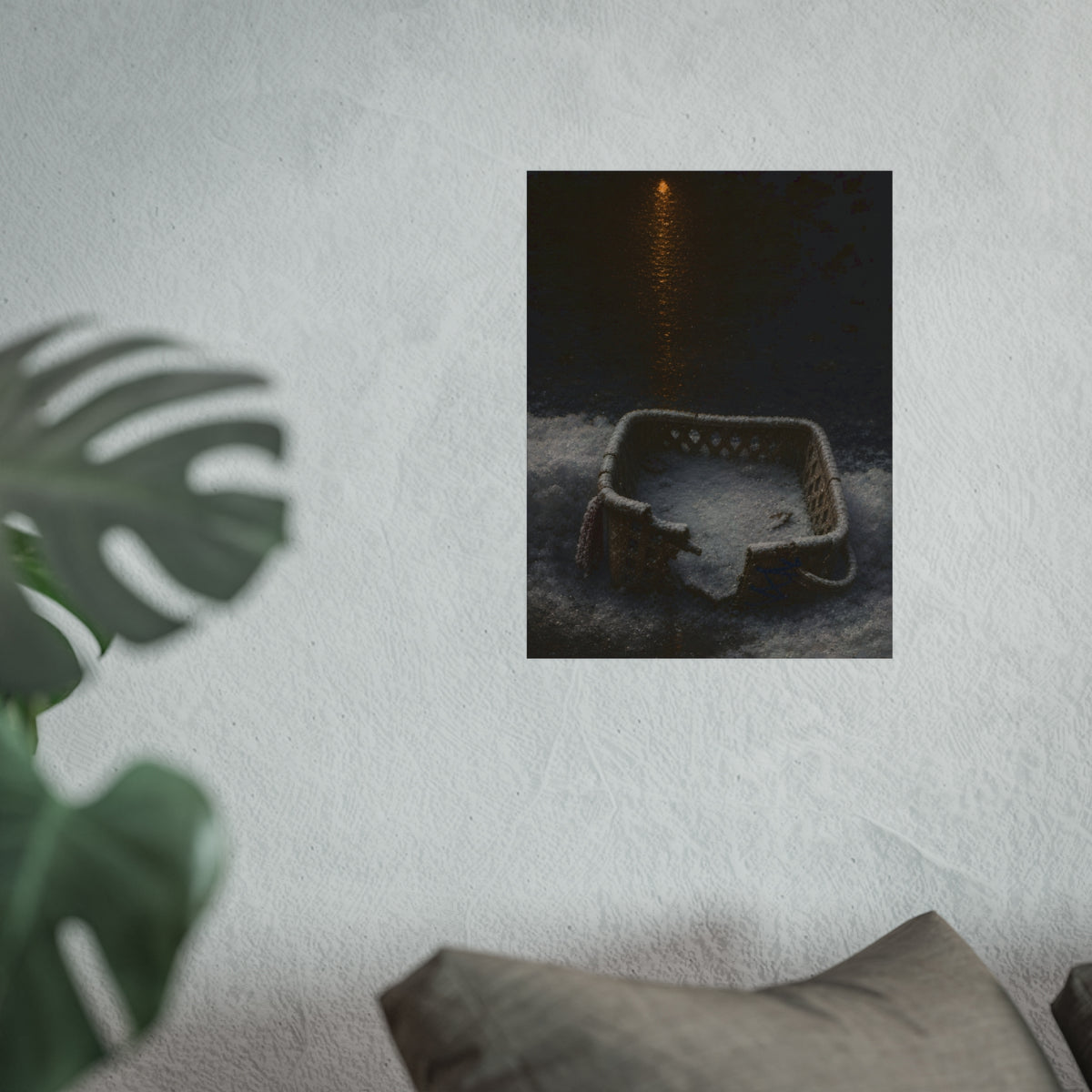 A cracked laundry basket half buried in snow under a distant lamp. The First Snow by Garabaggio, fine art print hanging in a room.