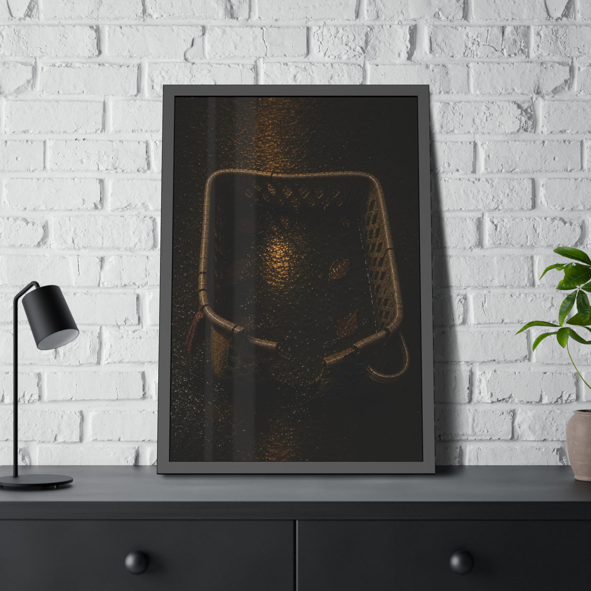 A cracked laundry basket holding rainwater and leaves on wet ground. The Basin of Rain (Laundry Basket) by Garabaggio, framed fine art print hanging in a room.