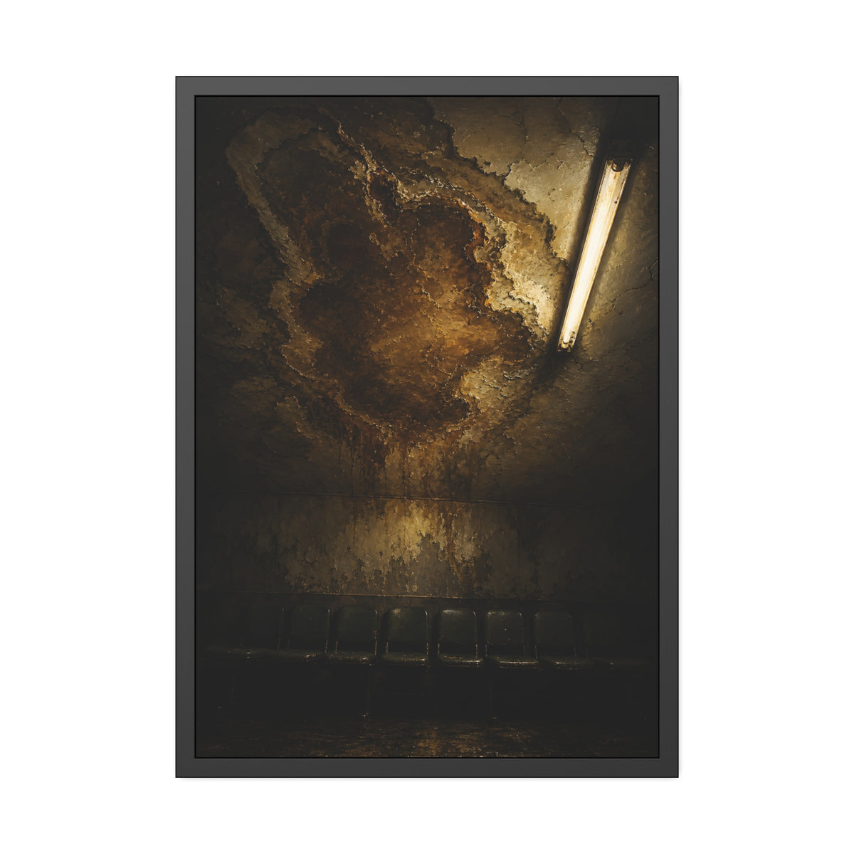 A brown water stain spreading across a ceiling above a row of chairs. The Stain Above the Row by Garabaggio, framed fine art print, 28″ x 40″.