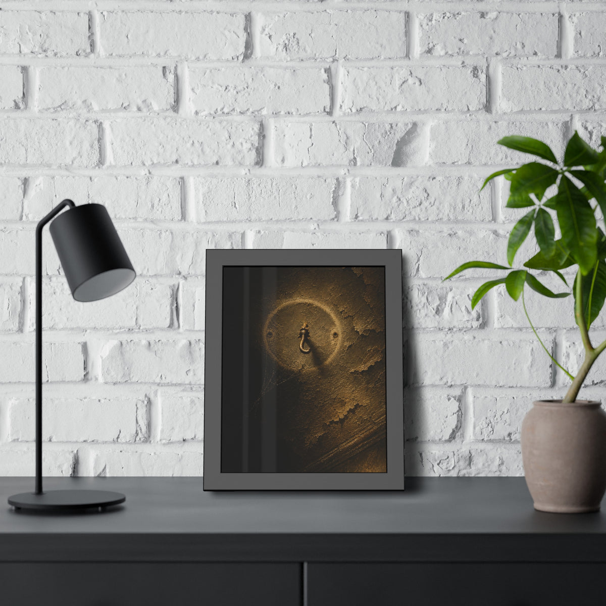 A small empty hook on a cracked ceiling, lit from one side. The Hook Without a Burden by Garabaggio, framed fine art print hanging in a room.