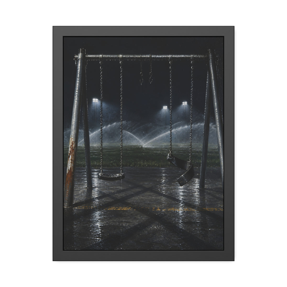 An empty swing set on wet asphalt, sprinklers arcing over the field. The Eleventh Hour: The Sprinklers by Garabaggio, framed fine art print, 18″ x 24″.