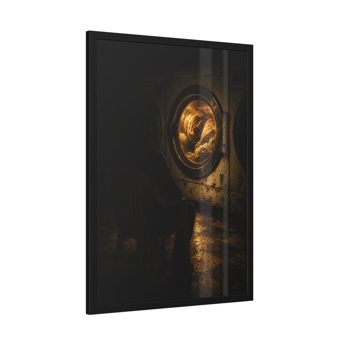 A person seated in a plastic chair facing a lit dryer drum. The Watcher in the Plastic Chair by Garabaggio, framed fine art print hanging in a room.