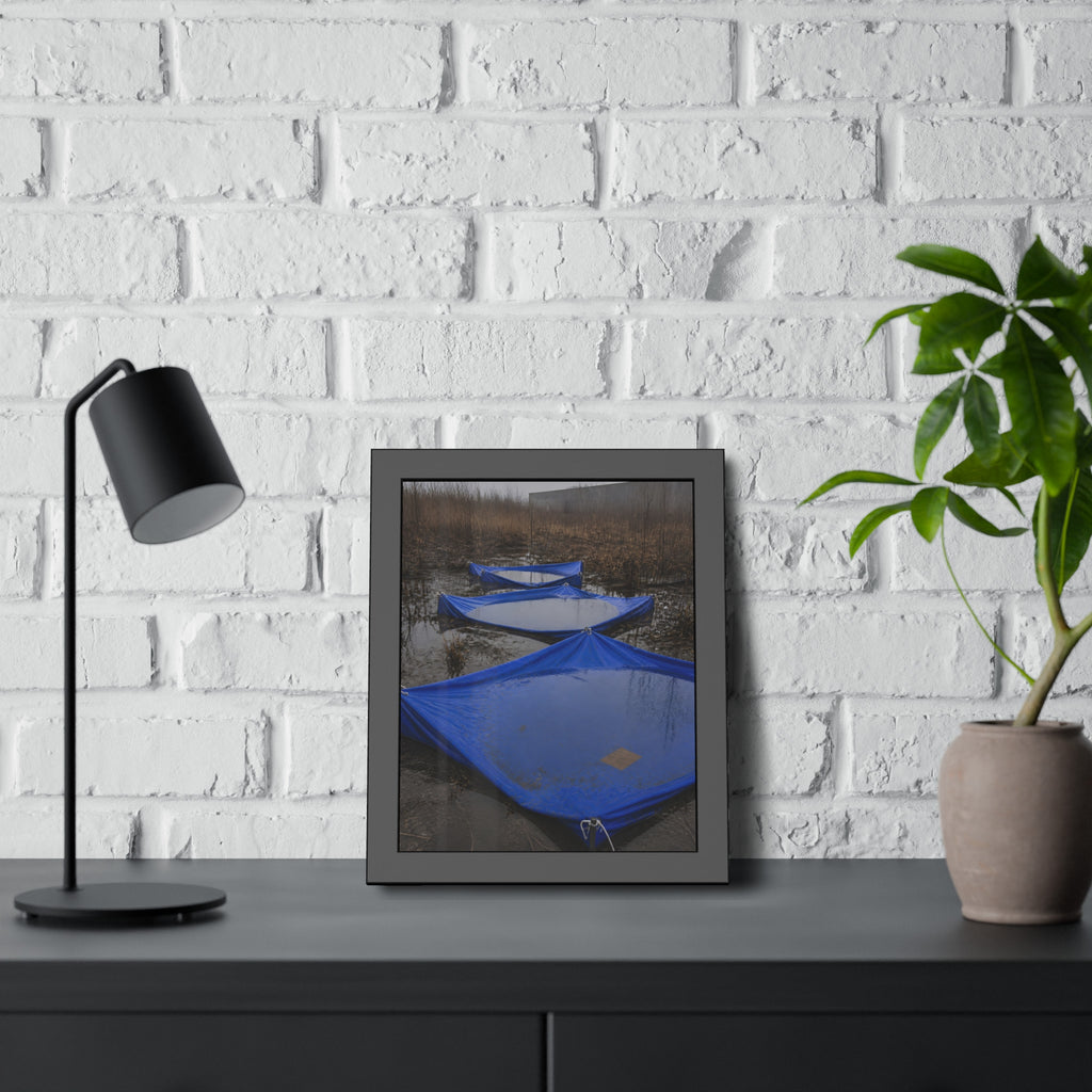 Three blue tarps holding pooled rainwater in a weedy vacant lot. Flooded in the Vacant Lot by Garabaggio, framed fine art print hanging in a room.