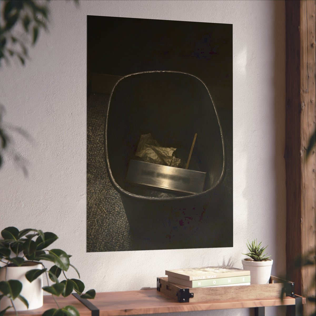 A metal nameplate lying in a black office waste bin on grey carpet. The Nameplate in the Waste Bin by Garabaggio, fine art print hanging in a room.