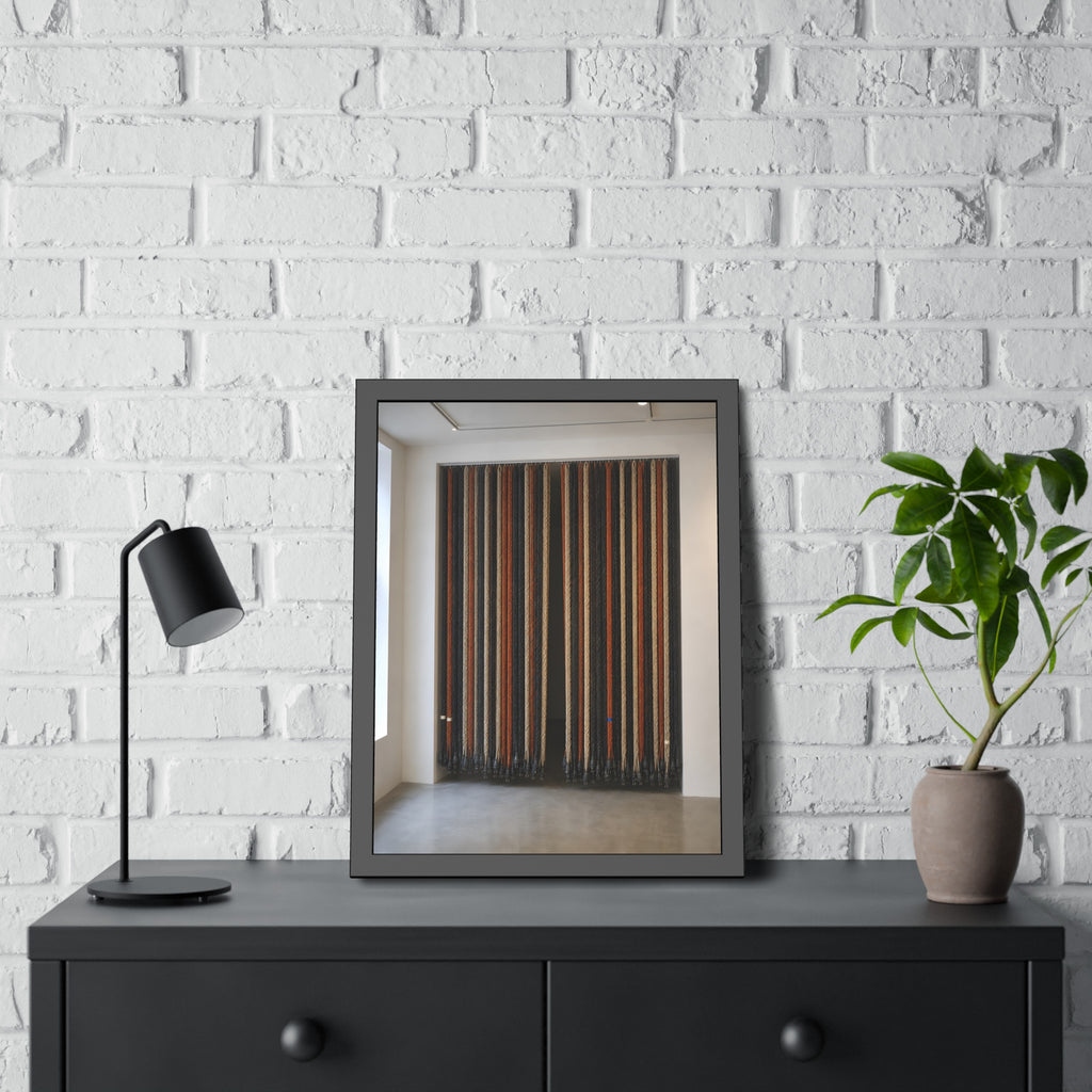 Hundreds of extension cords hung floor to ceiling across a bright white room. The Cord Curtain by Garabaggio, framed fine art print hanging in a room.