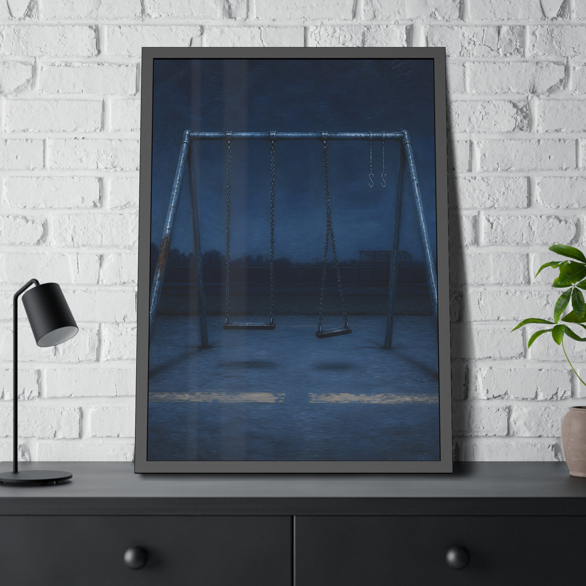 A swing set with two seats and two bare hooks in blue predawn light. The Fifth Hour: The Blue Before by Garabaggio, framed fine art print hanging in a room.