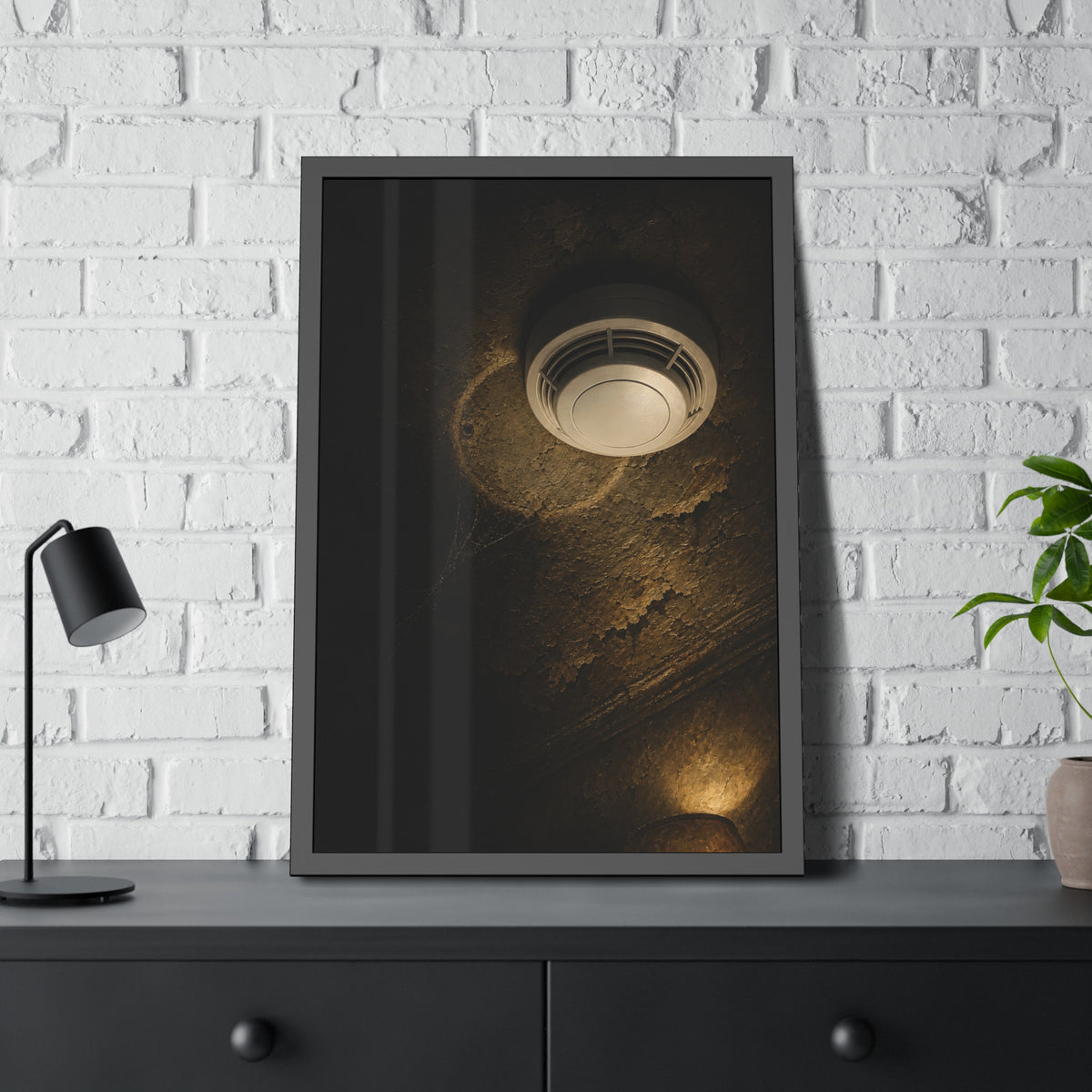 A new smoke detector on a stained ceiling next to an old mounting ring. The New Detector by Garabaggio, framed fine art print hanging in a room.