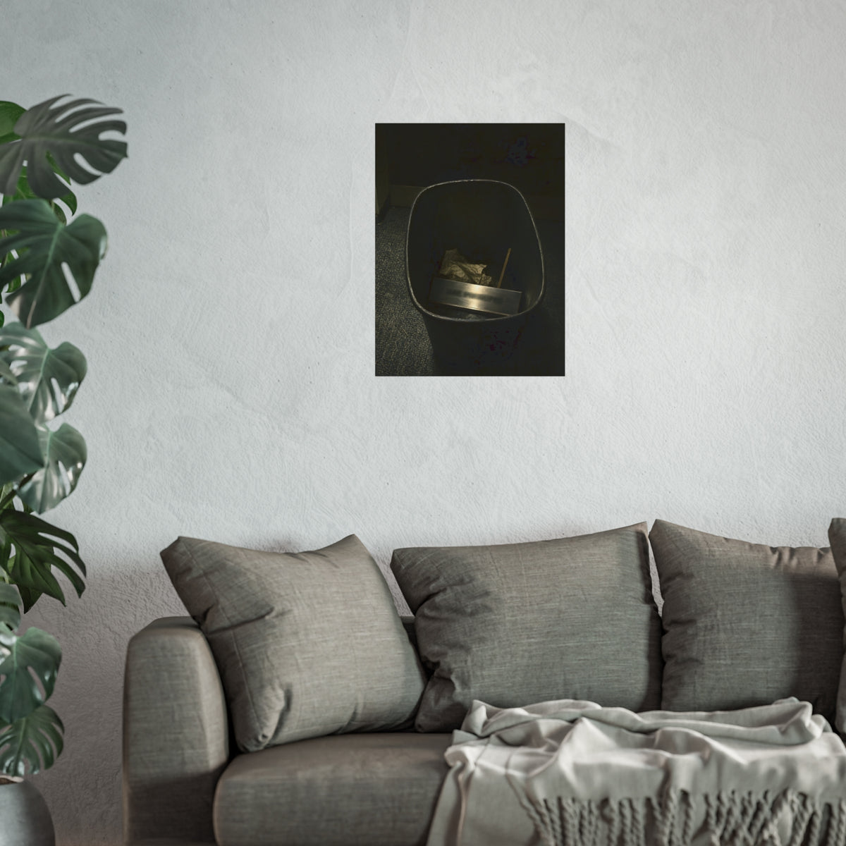 A metal nameplate lying in a black office waste bin on grey carpet. The Nameplate in the Waste Bin by Garabaggio, fine art print hanging in a room.