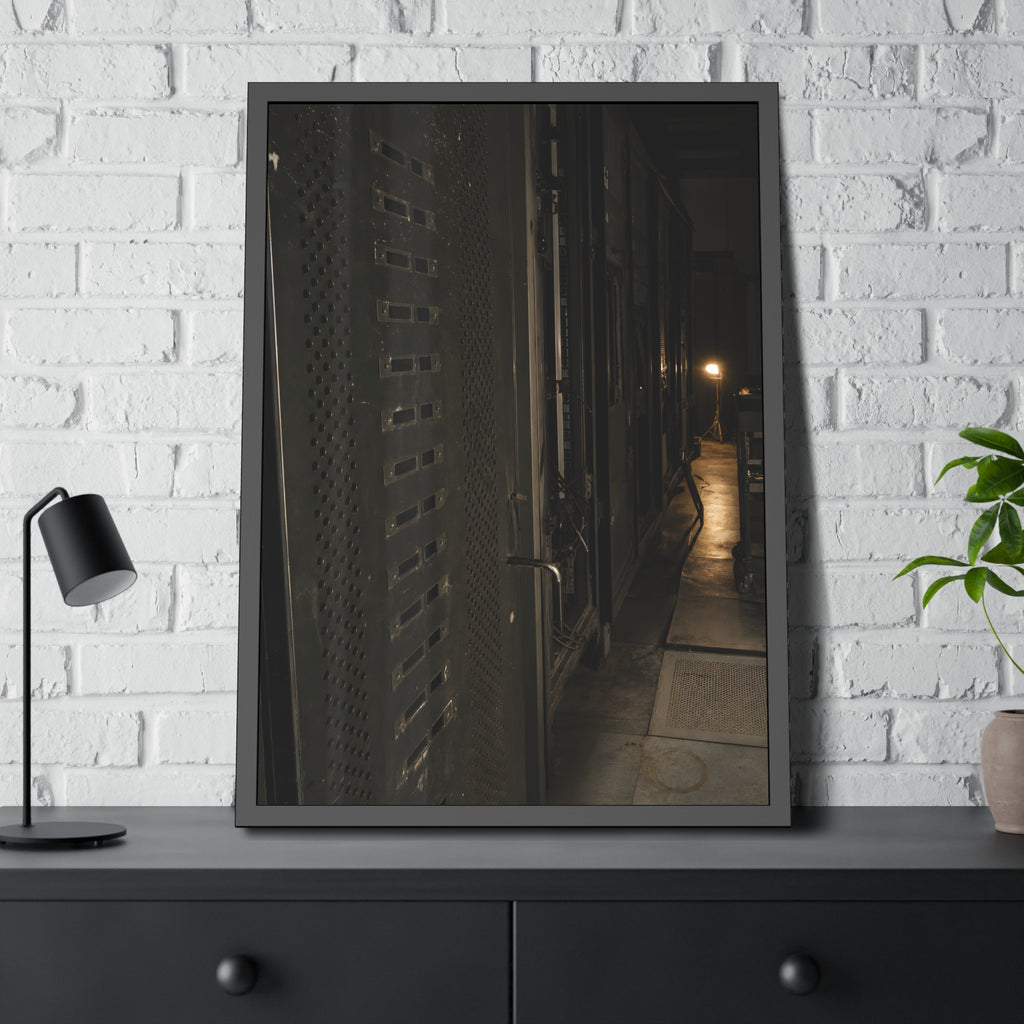 Rows of dark server cabinets with one work lamp glowing far down the aisle. Racks Without Light by Garabaggio, framed fine art print hanging in a room.