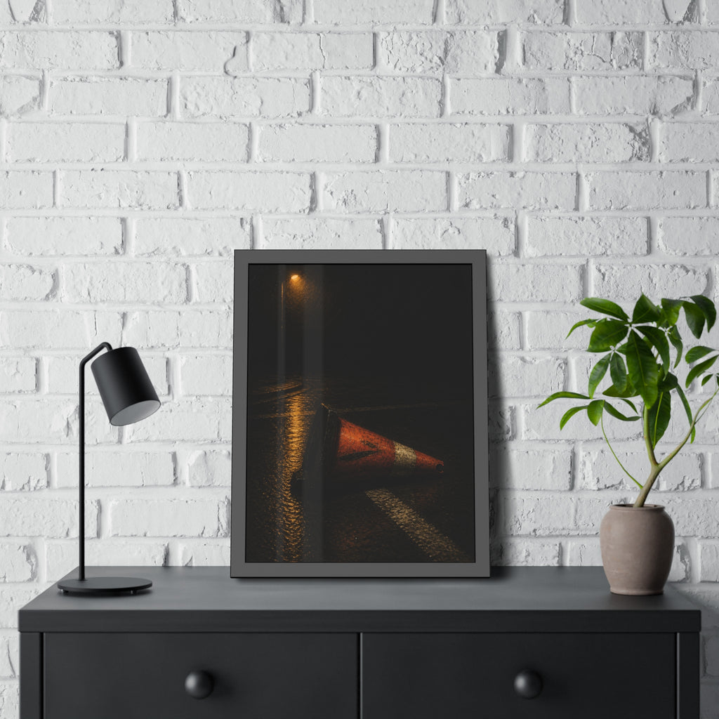 A toppled orange traffic cone on a wet road under a lone streetlight. The Taking by the Bumper by Garabaggio, framed fine art print hanging in a room.