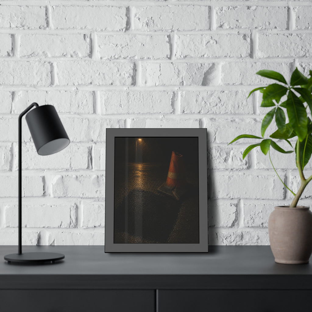 A traffic cone beside a fresh asphalt patch under a street lamp. The Sentinel After Repair by Garabaggio, framed fine art print hanging in a room.