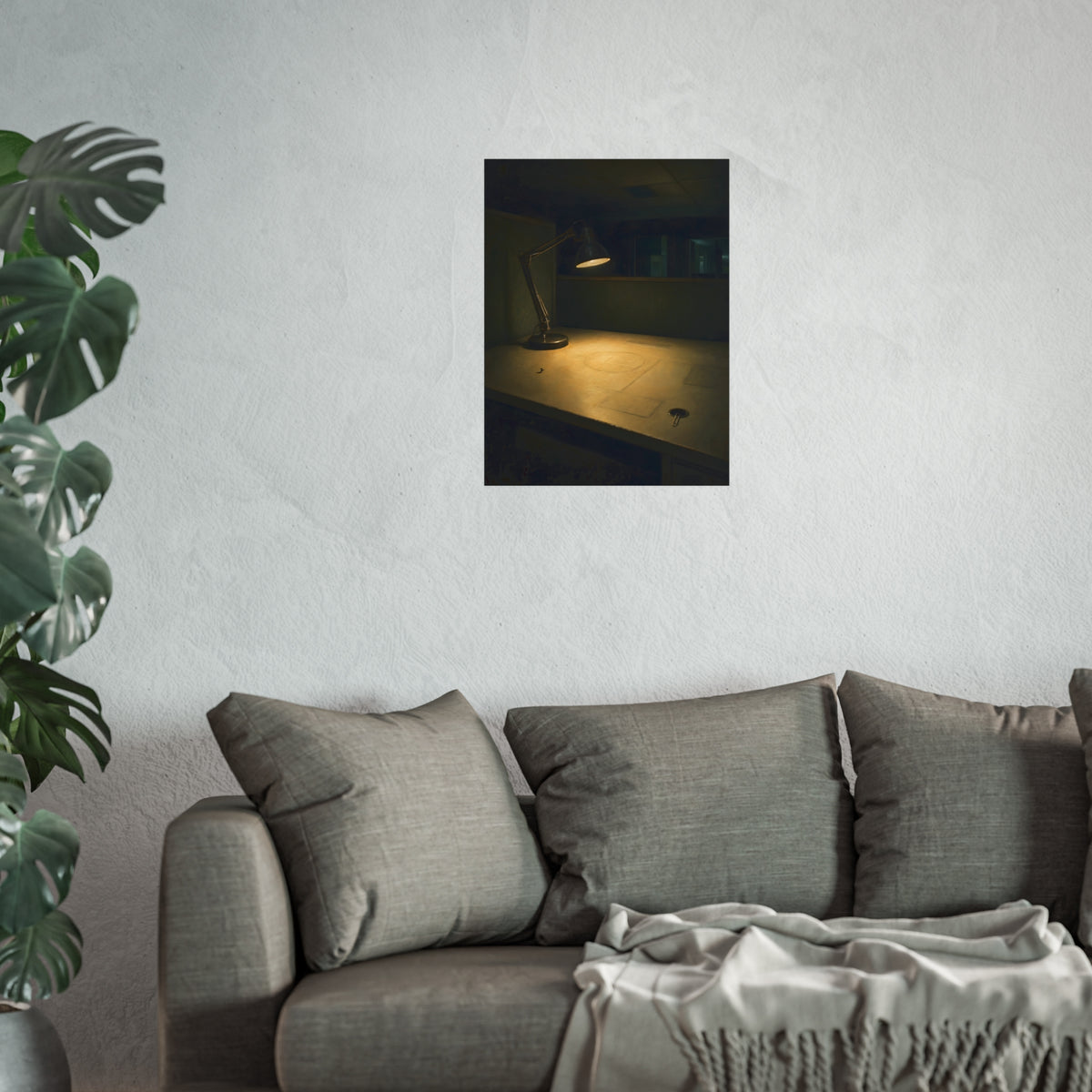 A lit desk lamp on an emptied office desk at night. The Desk Lamp Still Warm by Garabaggio, fine art print hanging in a room.