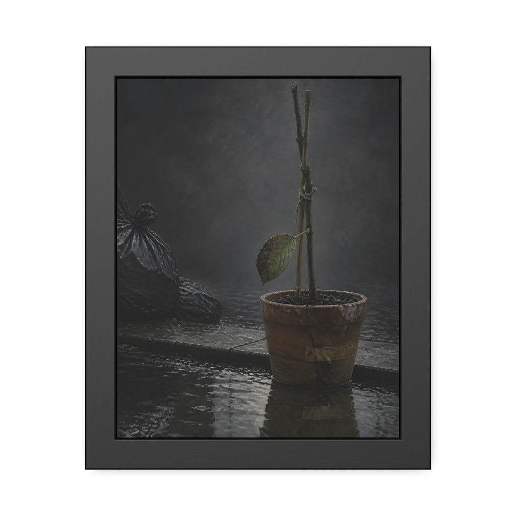 Bare tied stems in a clay pot on flooded pavement, one leaf remaining. The Grey Between by Garabaggio, framed fine art print, 11″ x 14″.