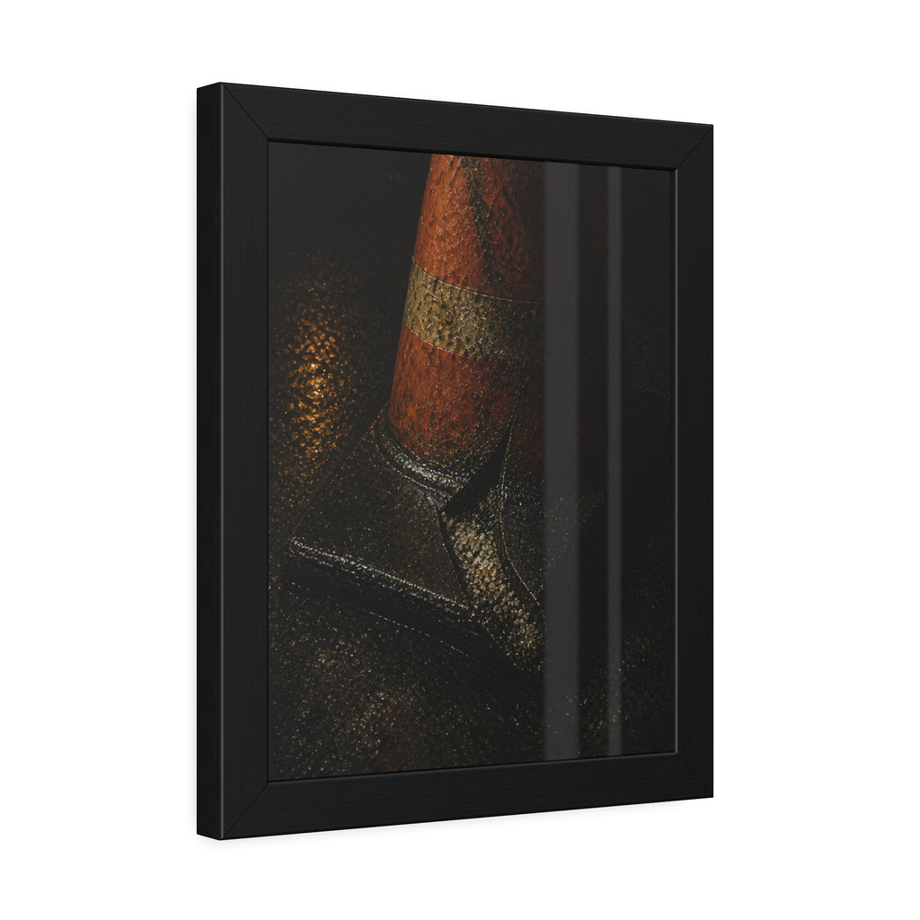 An orange traffic cone with a split base on wet asphalt at night. The Splitting of the Base by Garabaggio, framed fine art print hanging in a room.