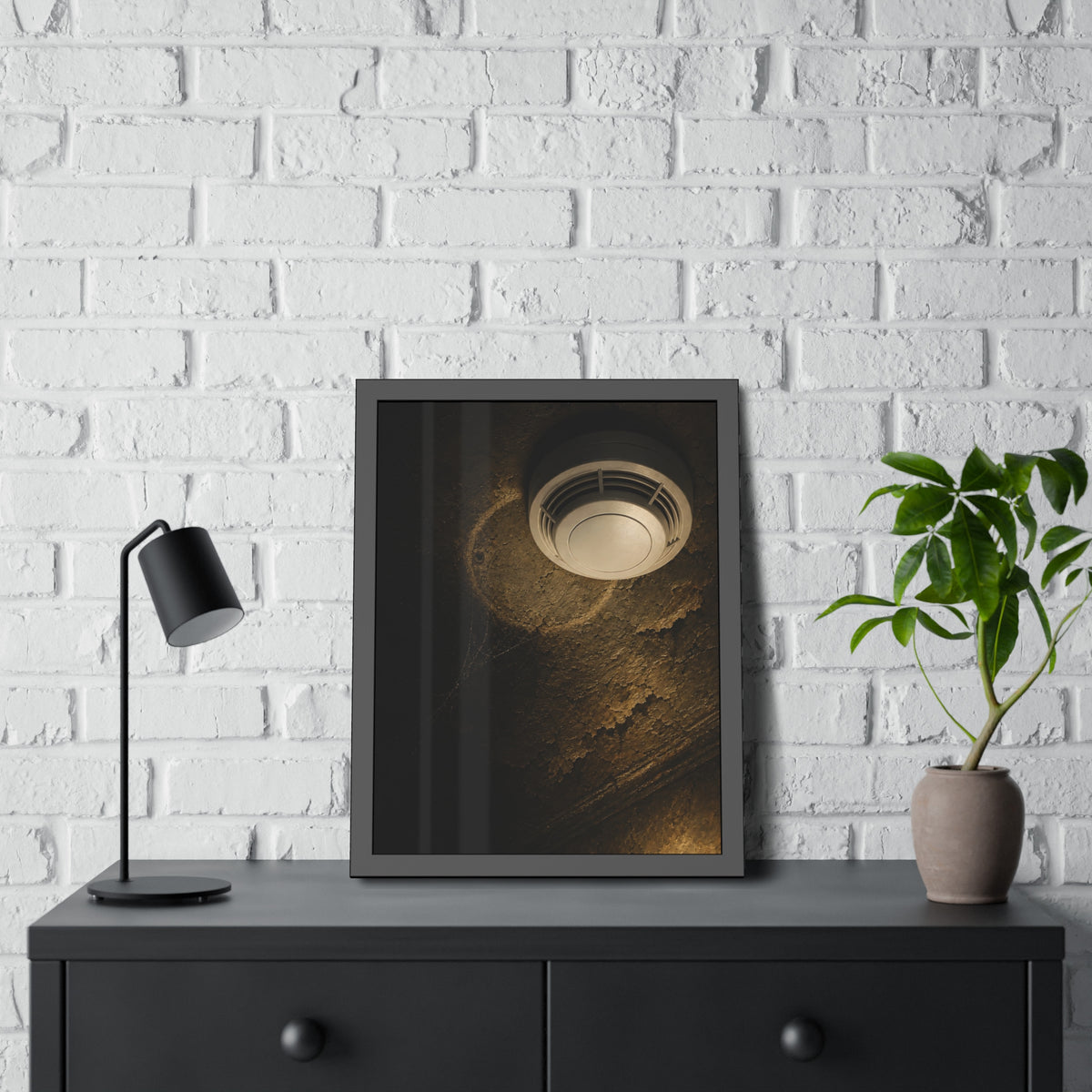 A new smoke detector on a stained ceiling next to an old mounting ring. The New Detector by Garabaggio, framed fine art print hanging in a room.
