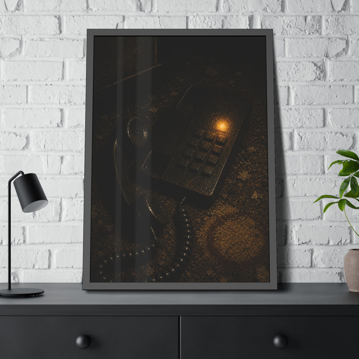A desk phone with the handset off the hook and one amber light glowing. The Line Still Rings by Garabaggio, framed fine art print hanging in a room.