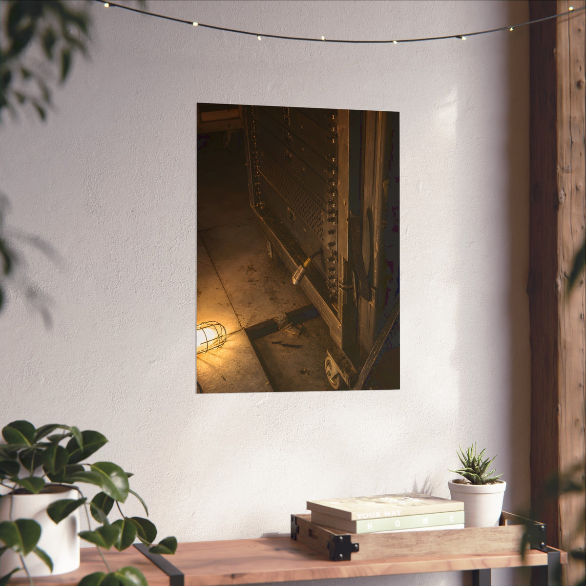 A server rack on a concrete floor beside a caged work light. The Silence at Cutover by Garabaggio, fine art print hanging in a room.