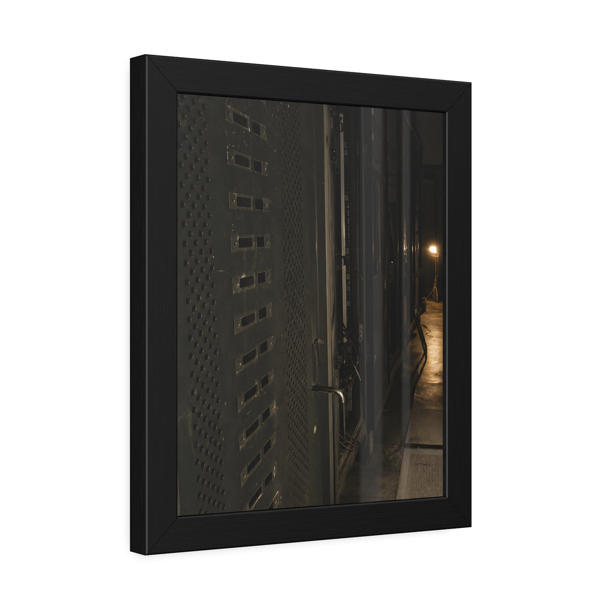 Rows of dark server cabinets with one work lamp glowing far down the aisle. Racks Without Light by Garabaggio, framed fine art print hanging in a room.