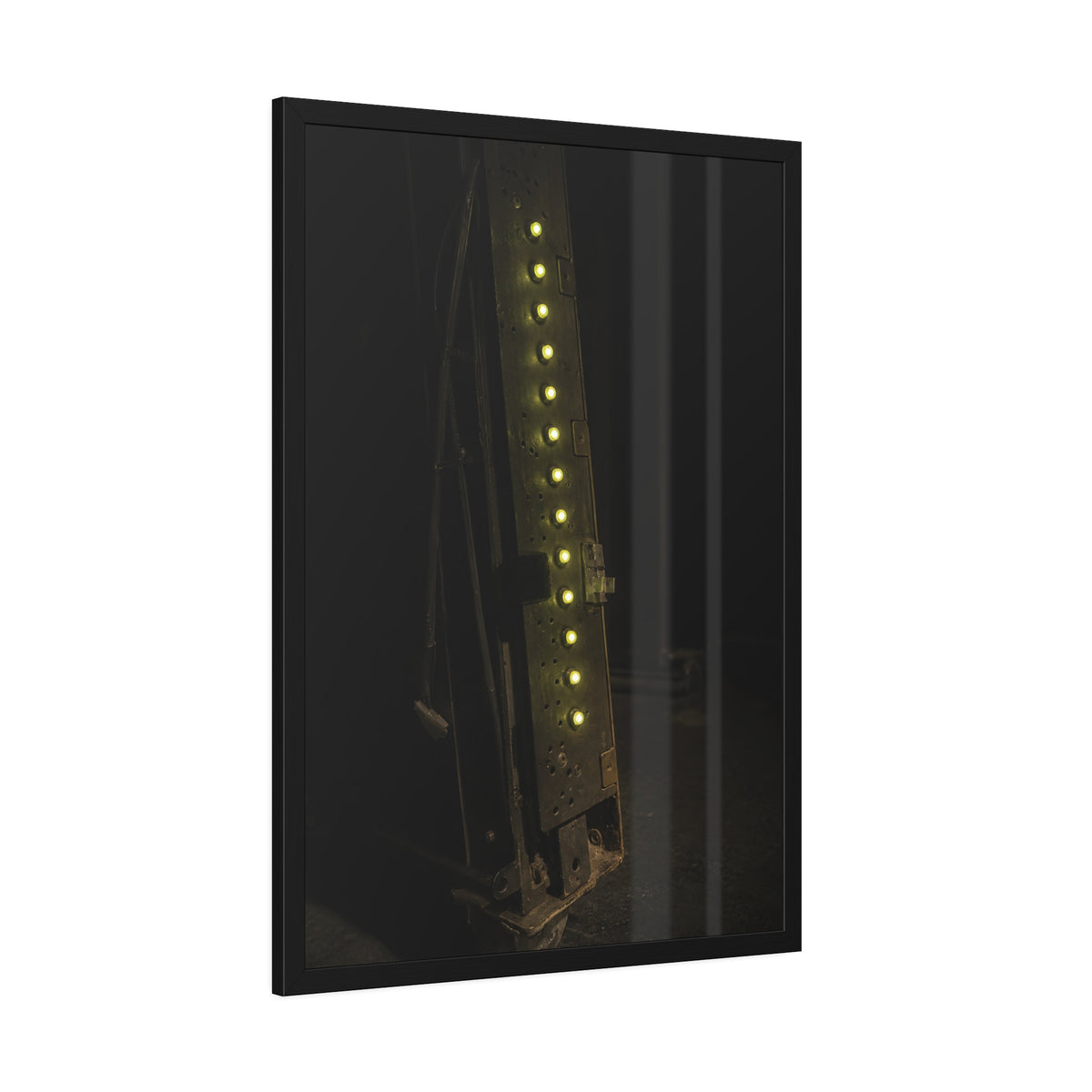 A dark rack panel with a vertical row of glowing green indicator lights. The First Green Choir by Garabaggio, framed fine art print hanging in a room.