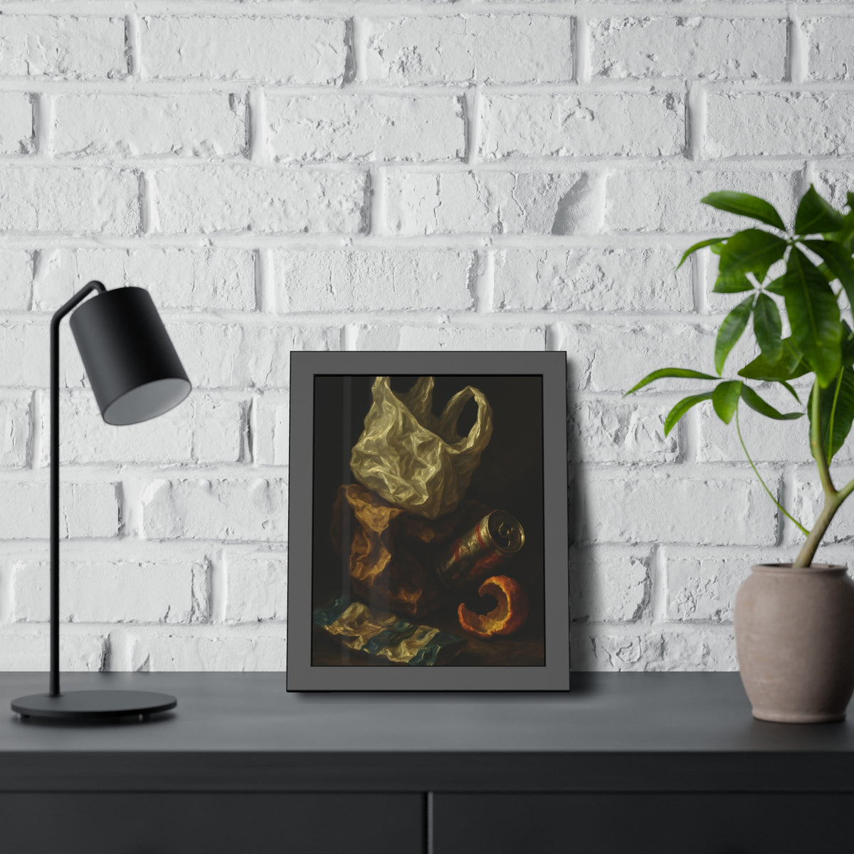 A plastic bag, crushed can and orange peel on a dim table. Still Life with Orange Peel and Resignation by Garabaggio, framed fine art print hanging in a room.