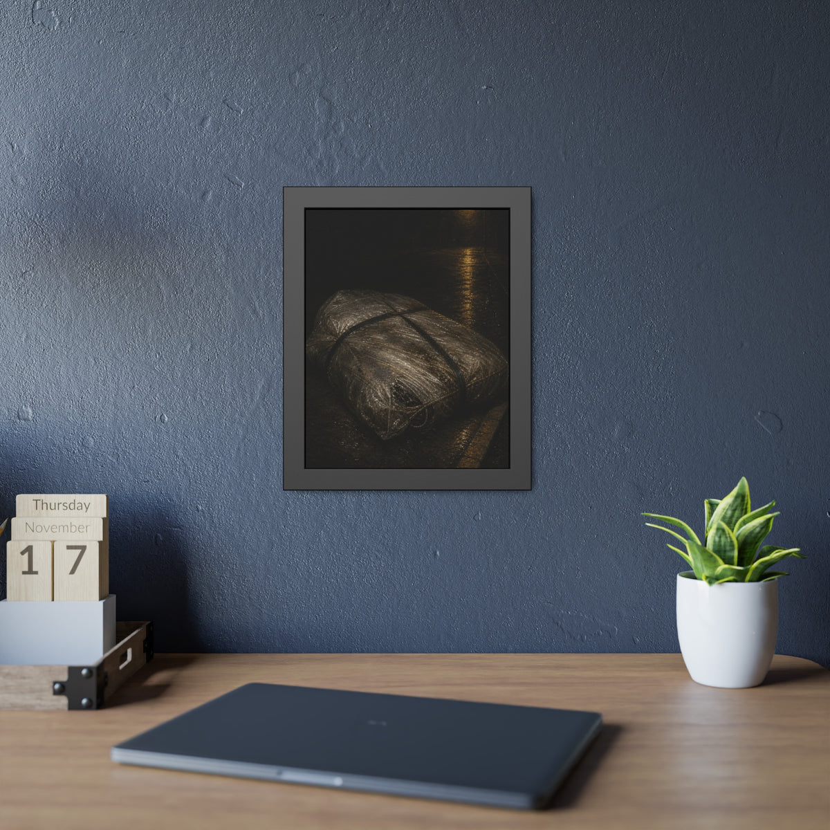 A mattress wrapped in plastic and strapped shut on a wet night street. The Municipal Shroud by Garabaggio, framed fine art print hanging in a room.