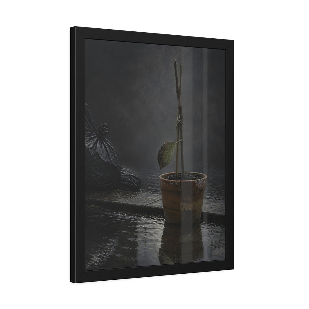 Bare tied stems in a clay pot on flooded pavement, one leaf remaining. The Grey Between by Garabaggio, framed fine art print hanging in a room.