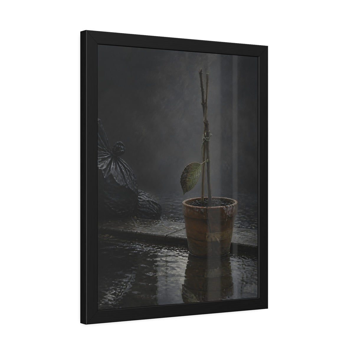 Bare tied stems in a clay pot on flooded pavement, one leaf remaining. The Grey Between by Garabaggio, framed fine art print hanging in a room.
