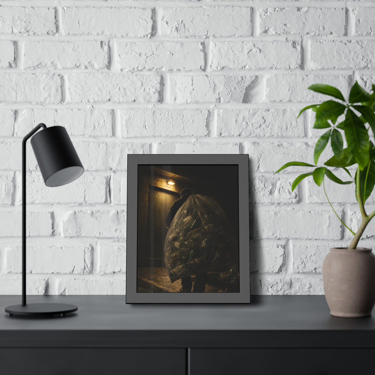 A man carrying a huge bag of bottles past a lit doorway at night. The Bag Carried Before Dawn by Garabaggio, framed fine art print hanging in a room.