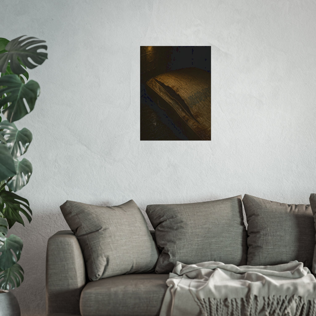 A mattress with its seam split open, lit warm against a dark wall. The Opening of the Ticking by Garabaggio, fine art print hanging in a room.