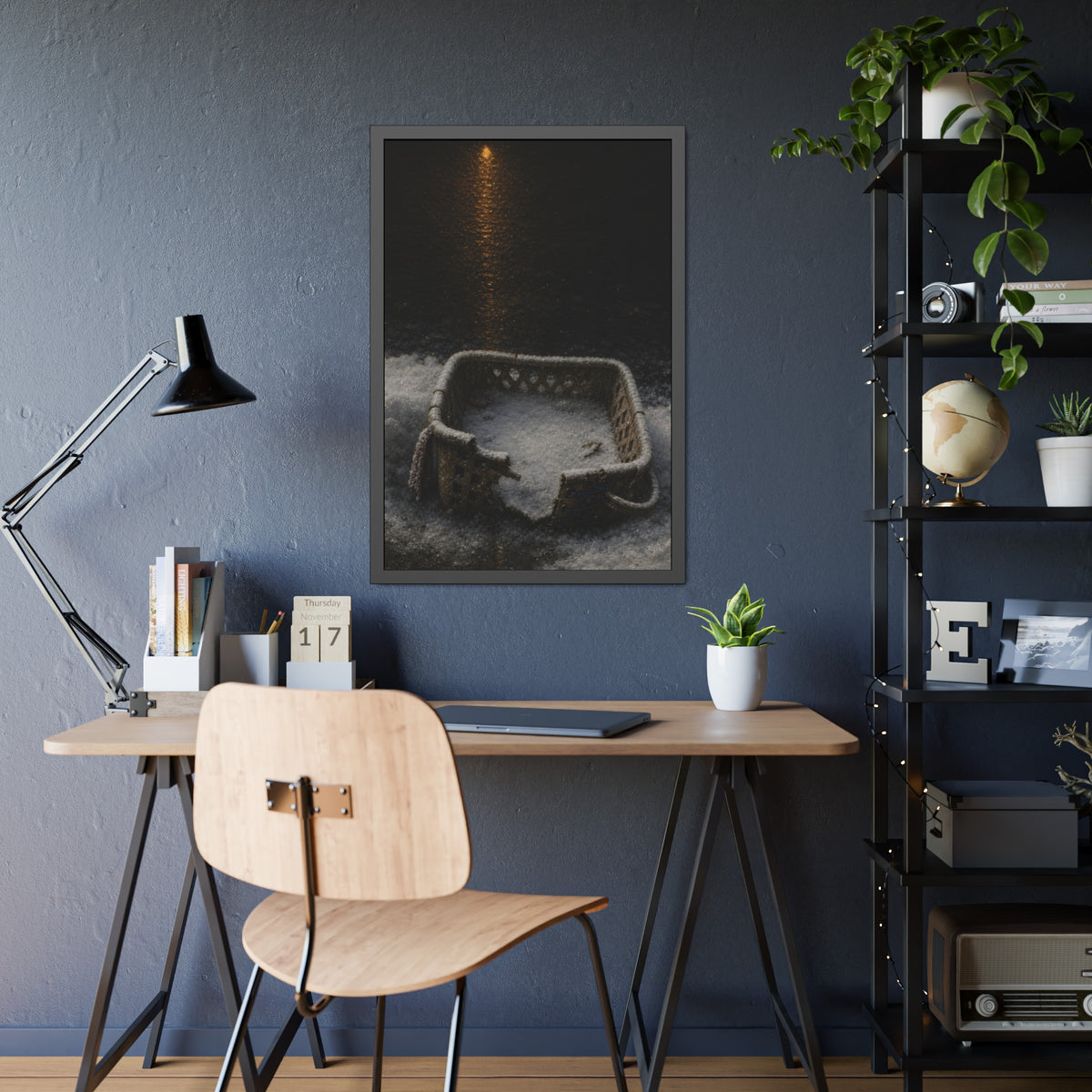 A cracked laundry basket half buried in snow under a distant lamp. The First Snow by Garabaggio, framed fine art print hanging in a room.
