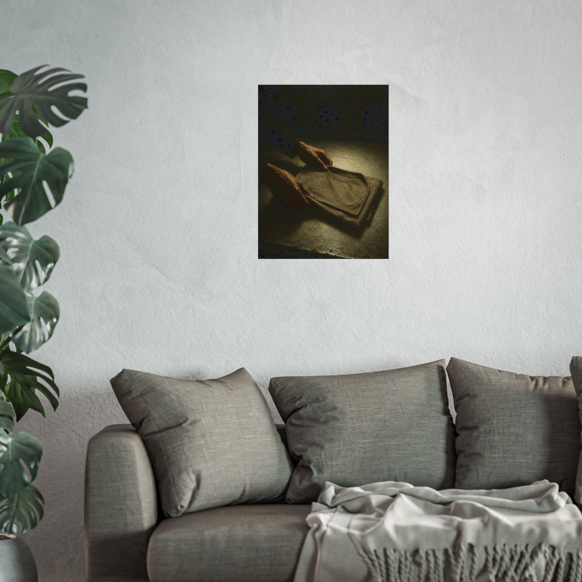 Two hands folding a shirt on a laundromat table with washers behind. The Folding at Two A.M by Garabaggio, fine art print hanging in a room.