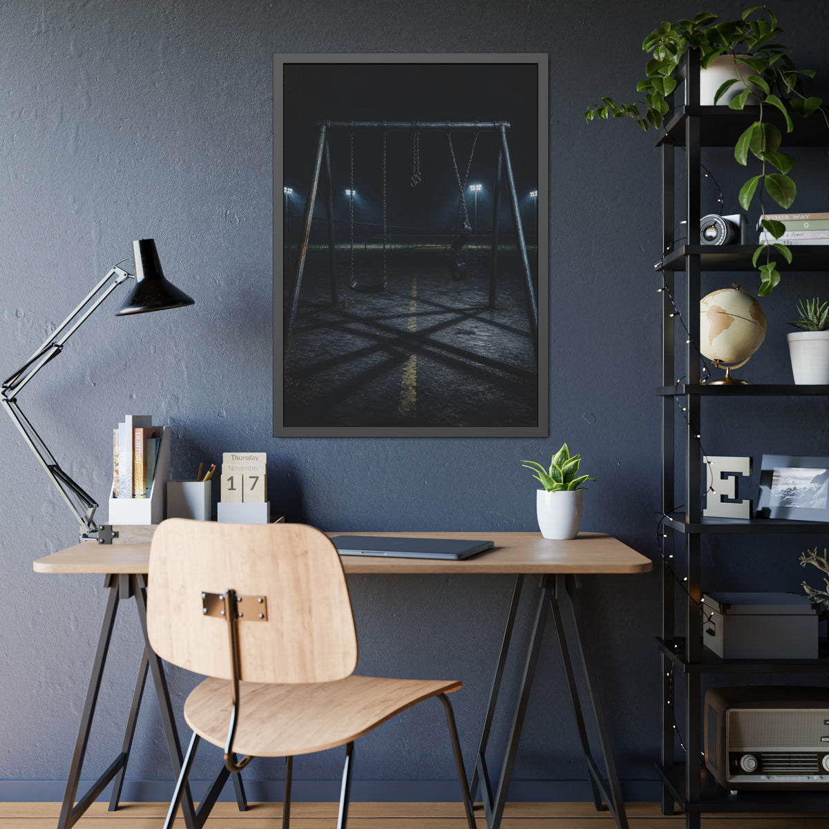 An empty swing set at night with field lights glowing behind it. The Ninth Hour: The Seat Still Moving by Garabaggio, framed fine art print hanging in a room.