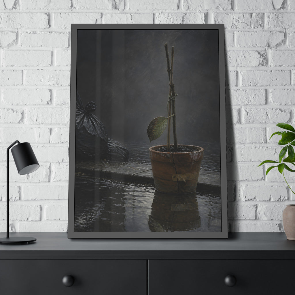 Bare tied stems in a clay pot on flooded pavement, one leaf remaining. The Grey Between by Garabaggio, framed fine art print hanging in a room.