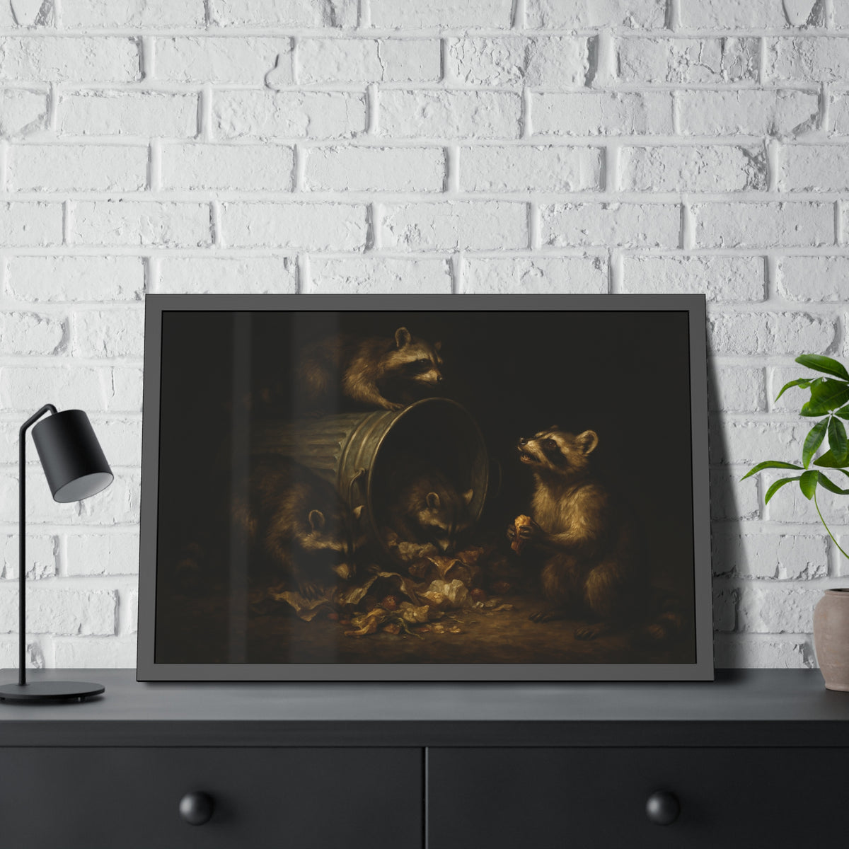 Four raccoons around a toppled metal trash can in the dark. The Last Bite by Garabaggio, framed fine art print hanging in a room.