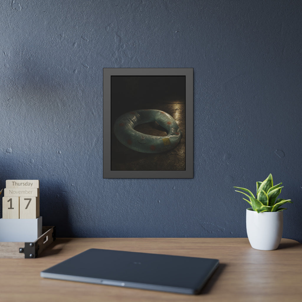 Deflated pool float ring on wet ground, lit from one side in the dark. After the Last Swim by Garabaggio, framed fine art print hanging in a room.