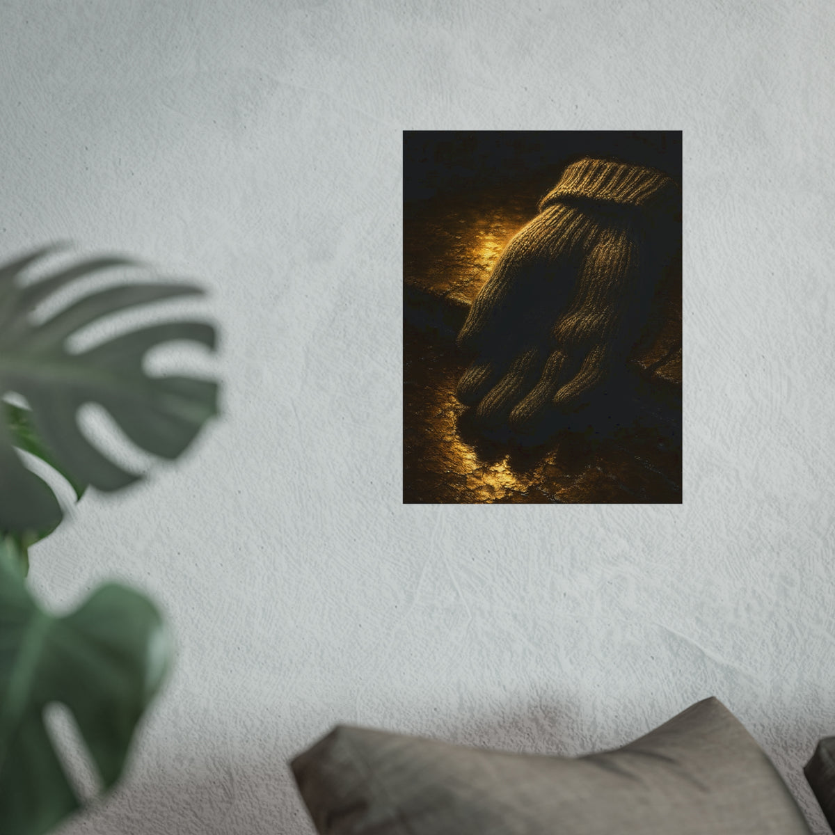 A knitted wool glove palm down on wet stone in gold light. The Presentation of the Woolen Glove by Garabaggio, fine art print hanging in a room.