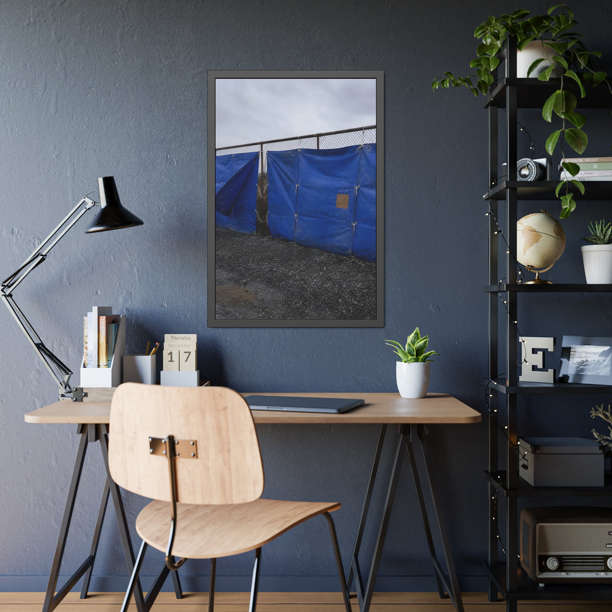 Blue tarps lashed to a chain link fence above gravel under grey sky. Drapery on the Fence by Garabaggio, framed fine art print hanging in a room.
