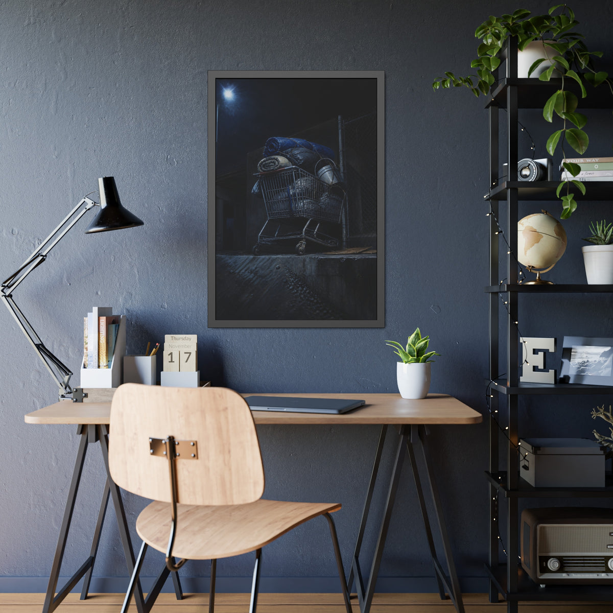 A shopping cart piled with bedding and buckets under a streetlamp. The Loading of Another Life by Garabaggio, framed fine art print hanging in a room.