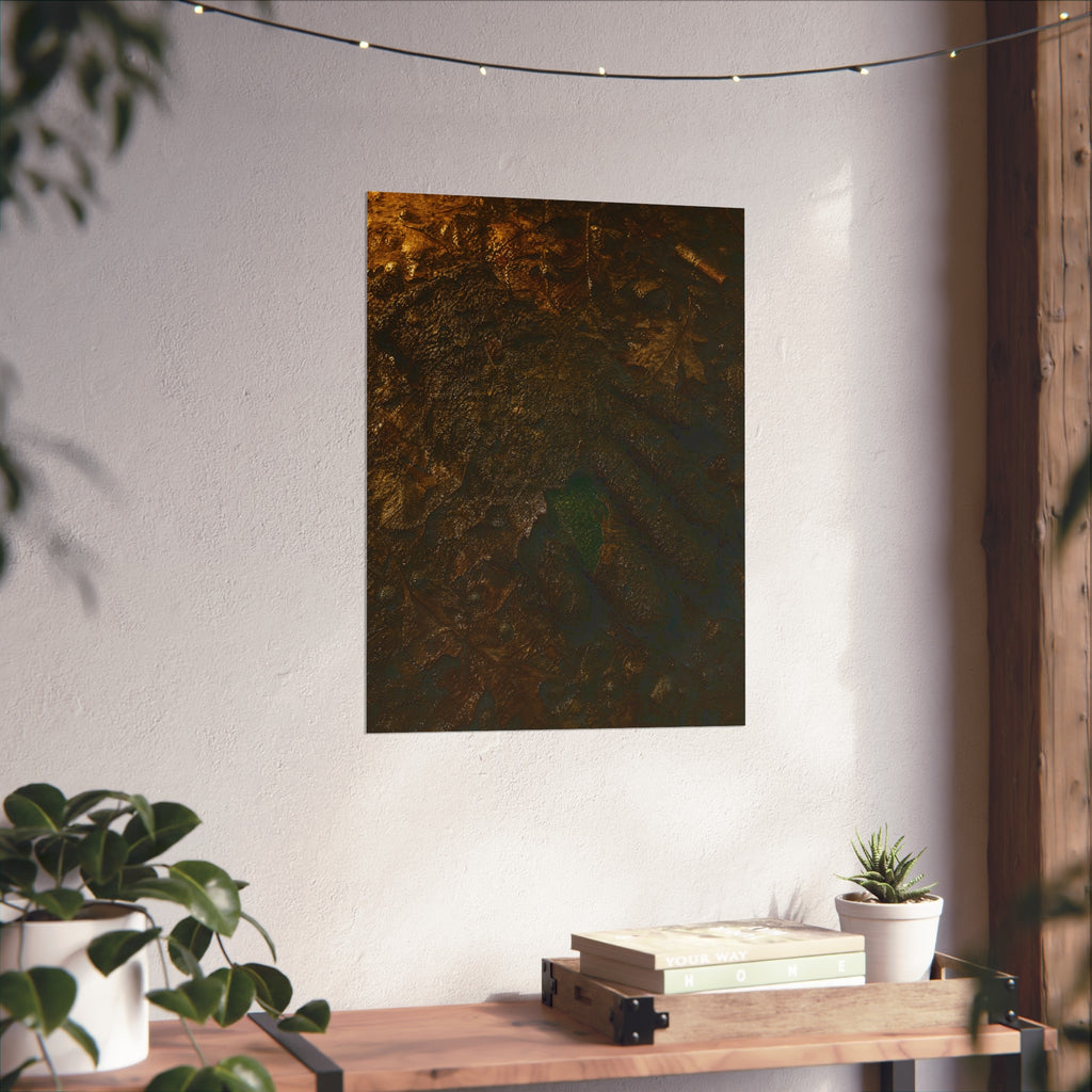 Wet mud and pressed oak leaves with a green scrap barely showing. The Reliquary of Mud and Leaf by Garabaggio, fine art print hanging in a room.